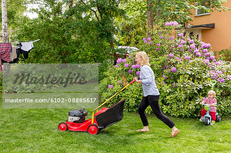 Woman mowing lawn