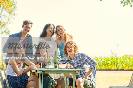 Friends posing for photo during outdoor meal together