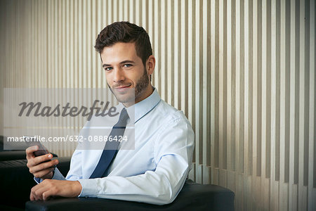 Businessman using smartphone, portrait