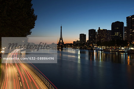 Light trails on a street along the River Seine at twilight, Paris, France