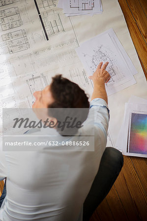 Architect looking at blueprint