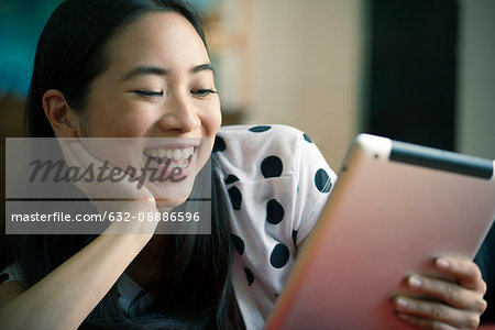 Young woman watching movie on digital tablet