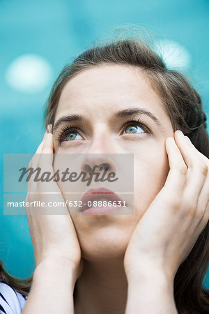 Woman looking up in thought, portrait