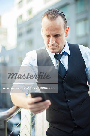 Businessman text messaging with cell phone