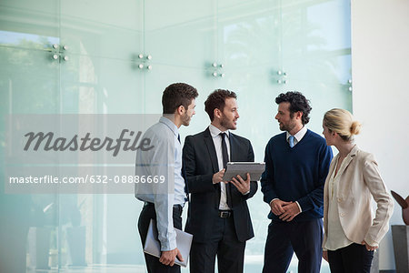 Business associates collaborating using digital tablet Business associates collaborating using digital tablet