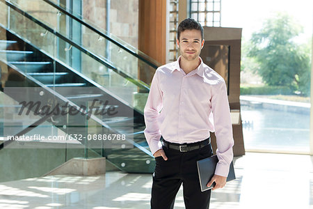 Young businessman standing in hotel lobby
