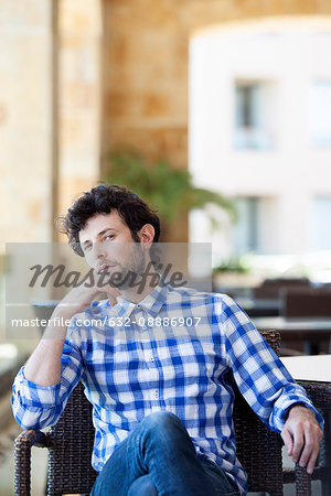 Man sitting with thoughtful expression on face