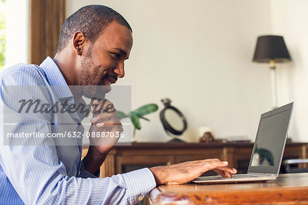 Man using laptop computer at home