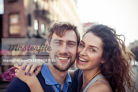 Couple embracing outdoors, portrait