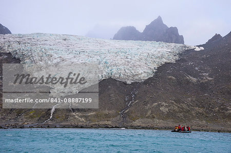 Tourists on a zodiac watching a glacier on Elephant Island, South Shetland Islands, Antarctica, Polar Regions