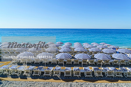 Blue and white beach parasols, Nice, Alpes-Maritimes, Cote d'Azur, Provence, French Riviera, France, Mediterranean, Europe Blue and white beach parasols, Nice, Alpes-Maritimes, Cote d'Azur, Provence, French Riviera, France, Mediterranean, Europe