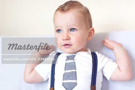 adorable toddler with blue eyes smiling and enjoying time at home