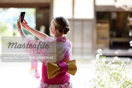 Caucasian woman wearing yukata in traditional Japanese house