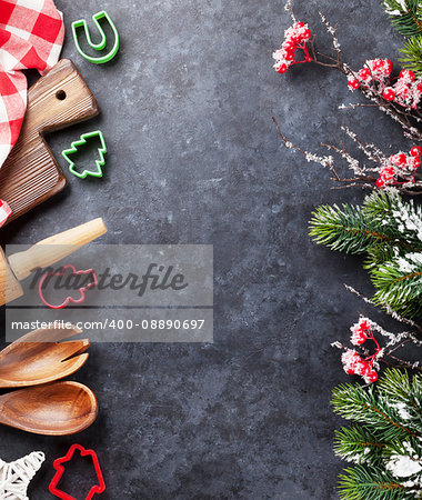 Christmas cooking utensils and snow tree on stone table. Top view with copy space