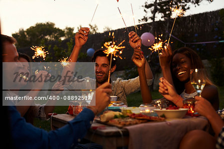 Friends With Sparklers Eating Food And Enjoying Party