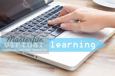 Virtual learning concept - hand tounching laptop keyboard