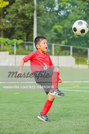 Japanese kid playing soccer