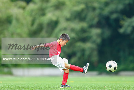 Japanese kid playing soccer