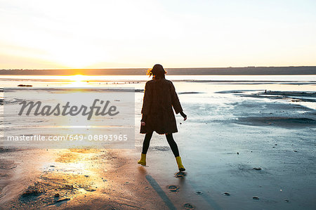 Woman enjoying beach at sunset