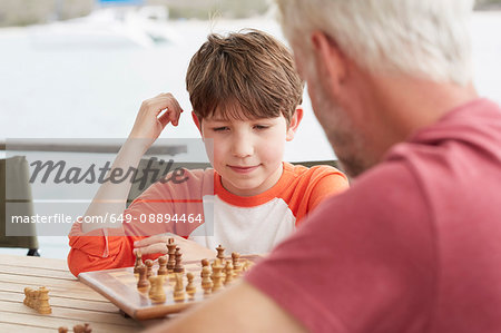 Grandfather and grandson playing chess