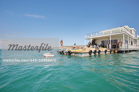 Family having fun on houseboat sun deck, Kraalbaai, South Africa