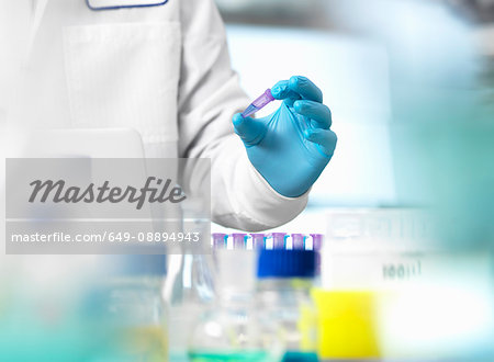 Life Science, scientist holding a sample in a eppendorf vial during an experiment in the laboratory Life Science, scientist holding a sample in a eppendorf vial during an experiment in the laboratory