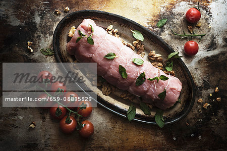 Raw pork fillet with mushrooms and tomatoes