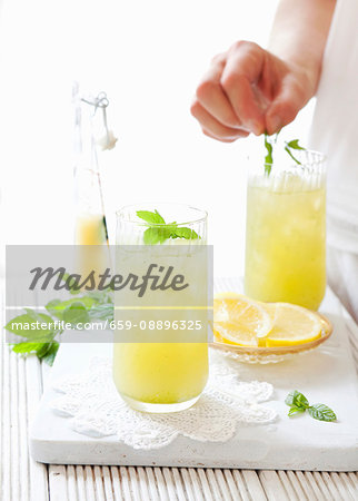 Apple lemonade being decorated with mint