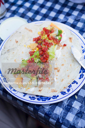 A burrito on a camping table