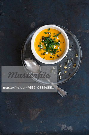 Pumpkin soup with chives and chopped pumpkins