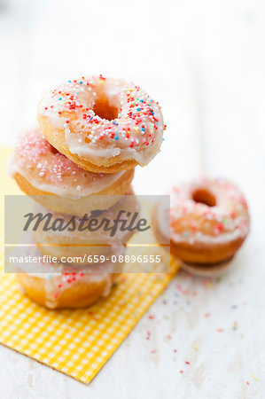 Doughnuts with icing sugar and colourful sugar sprinkles