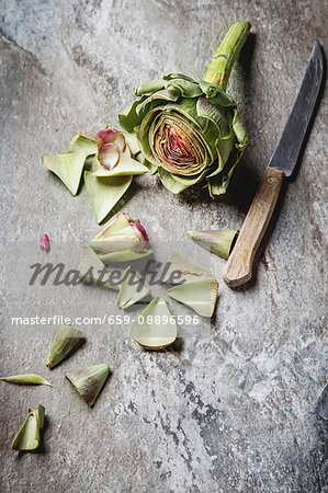 Baby Ripe Organic Artichokes on the rustic background Baby Ripe Organic Artichokes on the rustic background