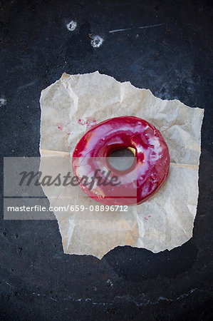 Blueberry donut on paper (top view)