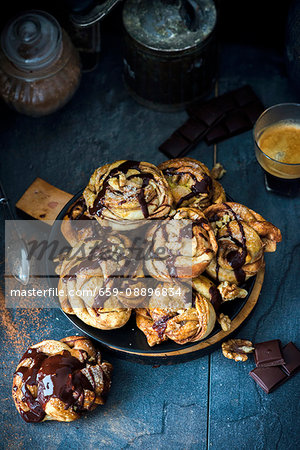 Swirl buns with a chocolate and cinnamon filling, chocolate sauce and walnuts