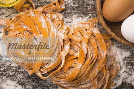Red pepper, fresh eggs and semolina handmade fettuccine pasta Red pepper, fresh eggs and semolina handmade fettuccine pasta