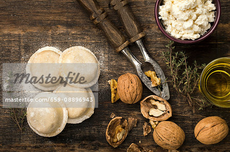 Homemade sorrentinos stuffed with ricotta and nuts in top of a wood table covered with semolina Homemade sorrentinos stuffed with ricotta and nuts in top of a wood table covered with semolina