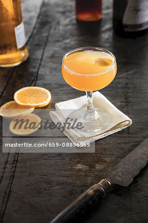 A champagne cocktail with orange garnish