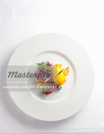 Mango sorbet with berries and icing sugar