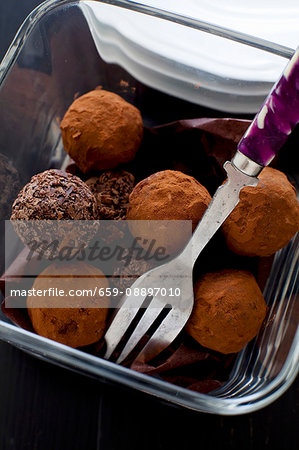 Chocolate truffles in a glass bowl with a fork
