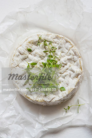 A whole Camembert with fresh thyme