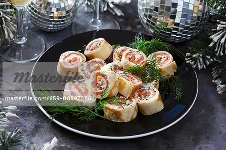 Smoked salmon rolls with fresh cheese for Christmas