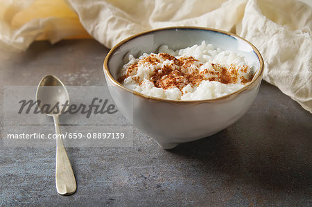 Traditional rice pudding with cinnamon Dark background Tasty and nutritious breakfast