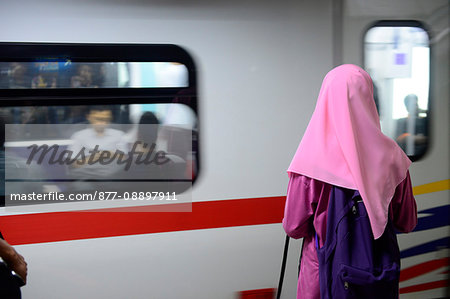 South-East Asia, Malaysia, Kuala Lumpur, veiled woman from the back waiting for the metro