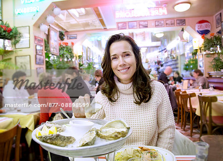 France, Trouville sur Mer, Woman in front of an oyster plate in the restaurant Les Vapeurs