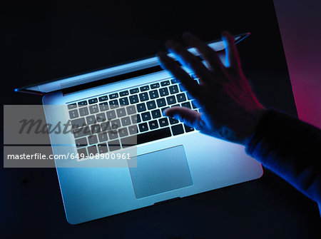 Hacking, man opening laptop computer
