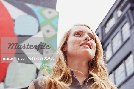 Women smiling, wall art in background, London, UK