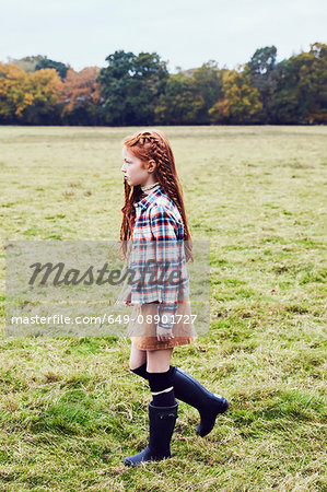 Young girl, walking through field