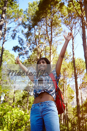 Young woman, hiking, arms raised, smiling, Cape Town, South Africa