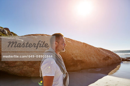 Mature man standing on beach, looking at view, Cape Town, South Africa