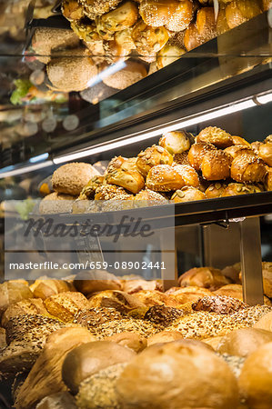 Various types of bread on shelves in a sales cabinet in the bakery